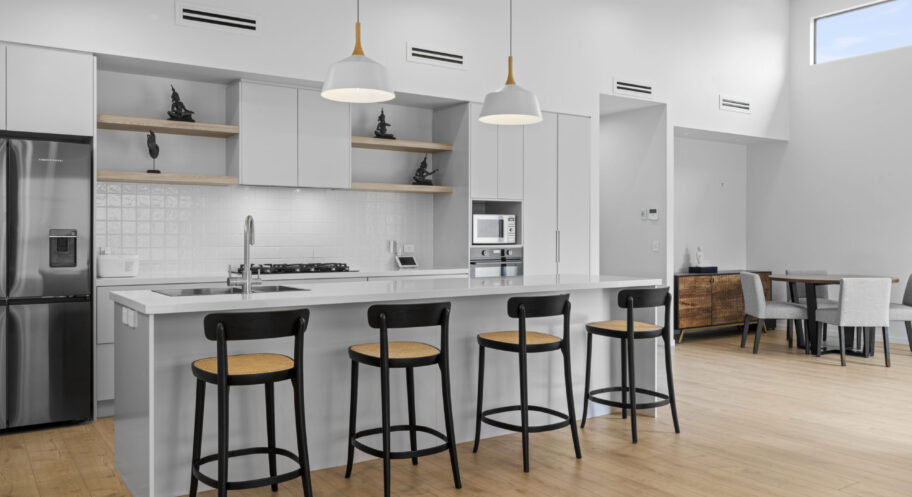 Tahmoor (2 of 44) Renovated white kitchen with island bench and bar stools in a Sydney home by Daylo Build