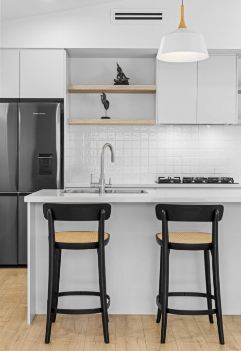 Custom kitchen with stone island bench and bar stools by Daylo Build
