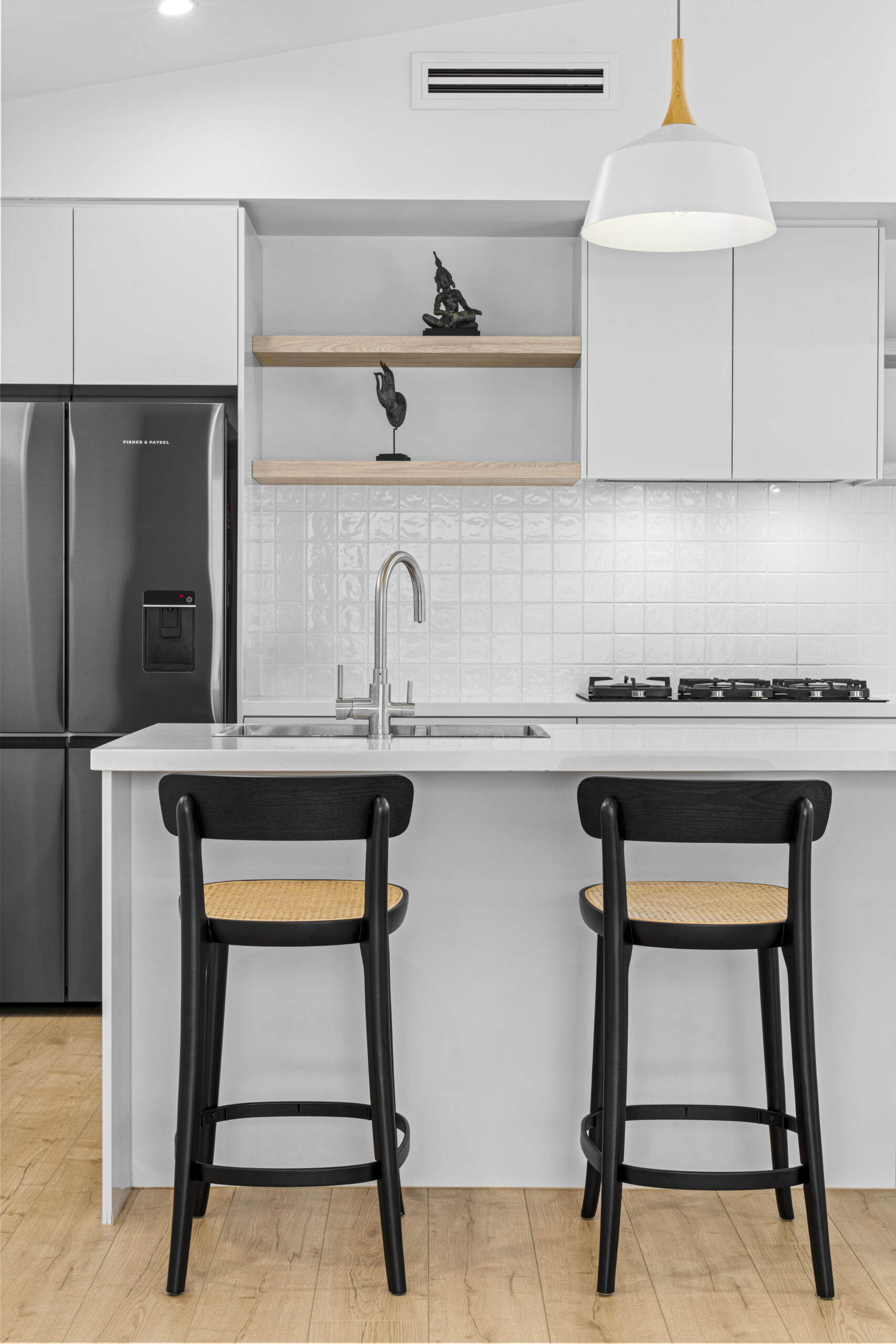 Custom kitchen with stone island bench and bar stools by Daylo Build