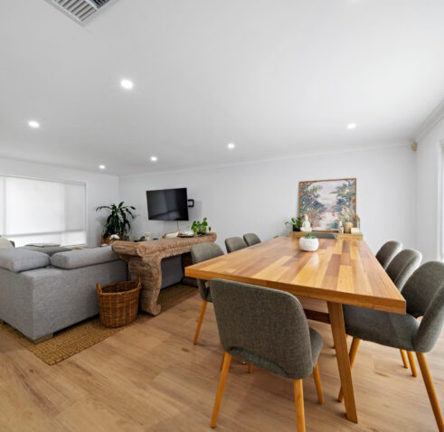 Transformation (13 of 32) Renovated open-plan living and dining area with timber dining table