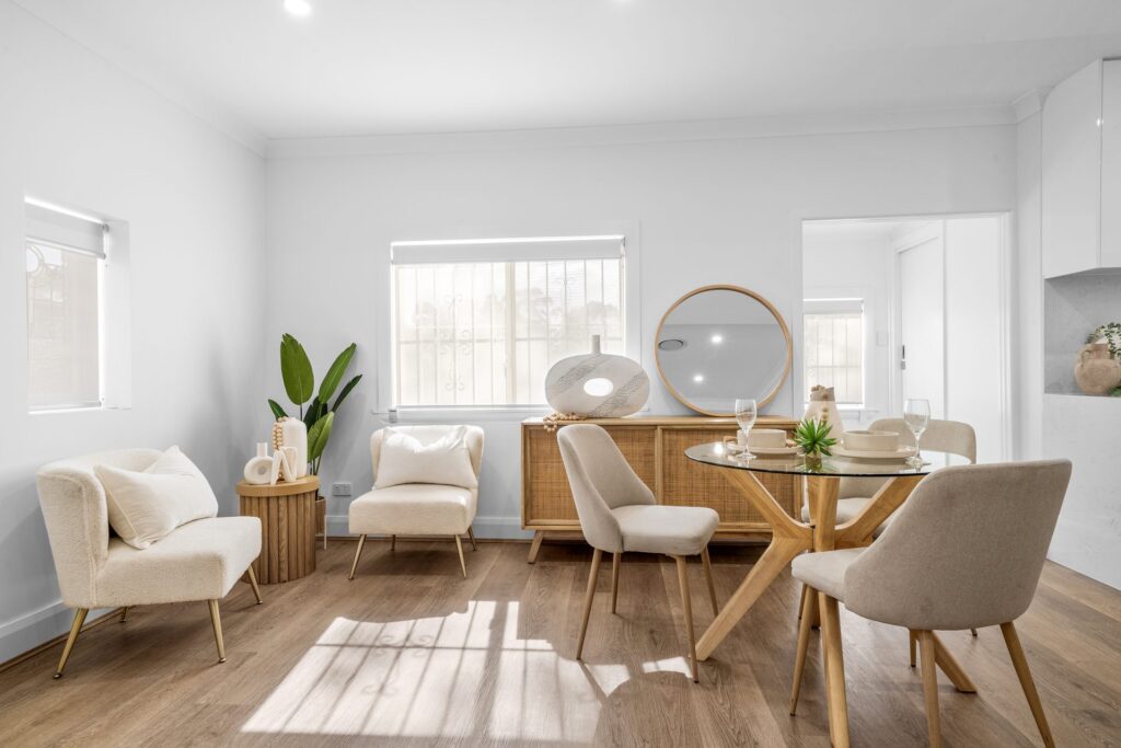 Renovated living and dining room with timber flooring and natural light in West Ryde by Daylo Build